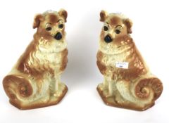A pair of Staffordshire pottery 19th century style models of dogs.