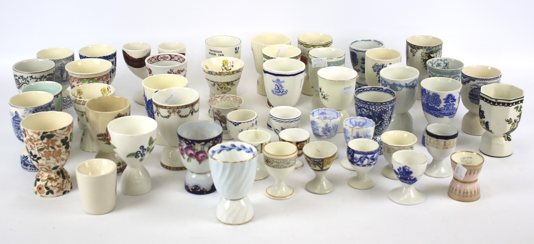A collection of English and Continental pottery and porcelain egg cups.