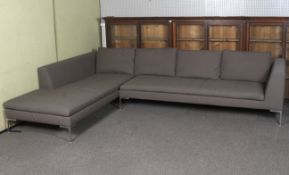 A Max Alto corner sofa by Antonio Citterio upholstered in grey.