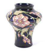 A Moorcroft Pottery blue-ground inverted baluster trial vase.