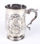 A silver embossed tankard.