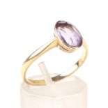 An amethyst single stone ring. The pale-violet, oval mixed-cut stone approx. 1.