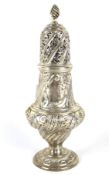 A decorative silver sugar sifter.