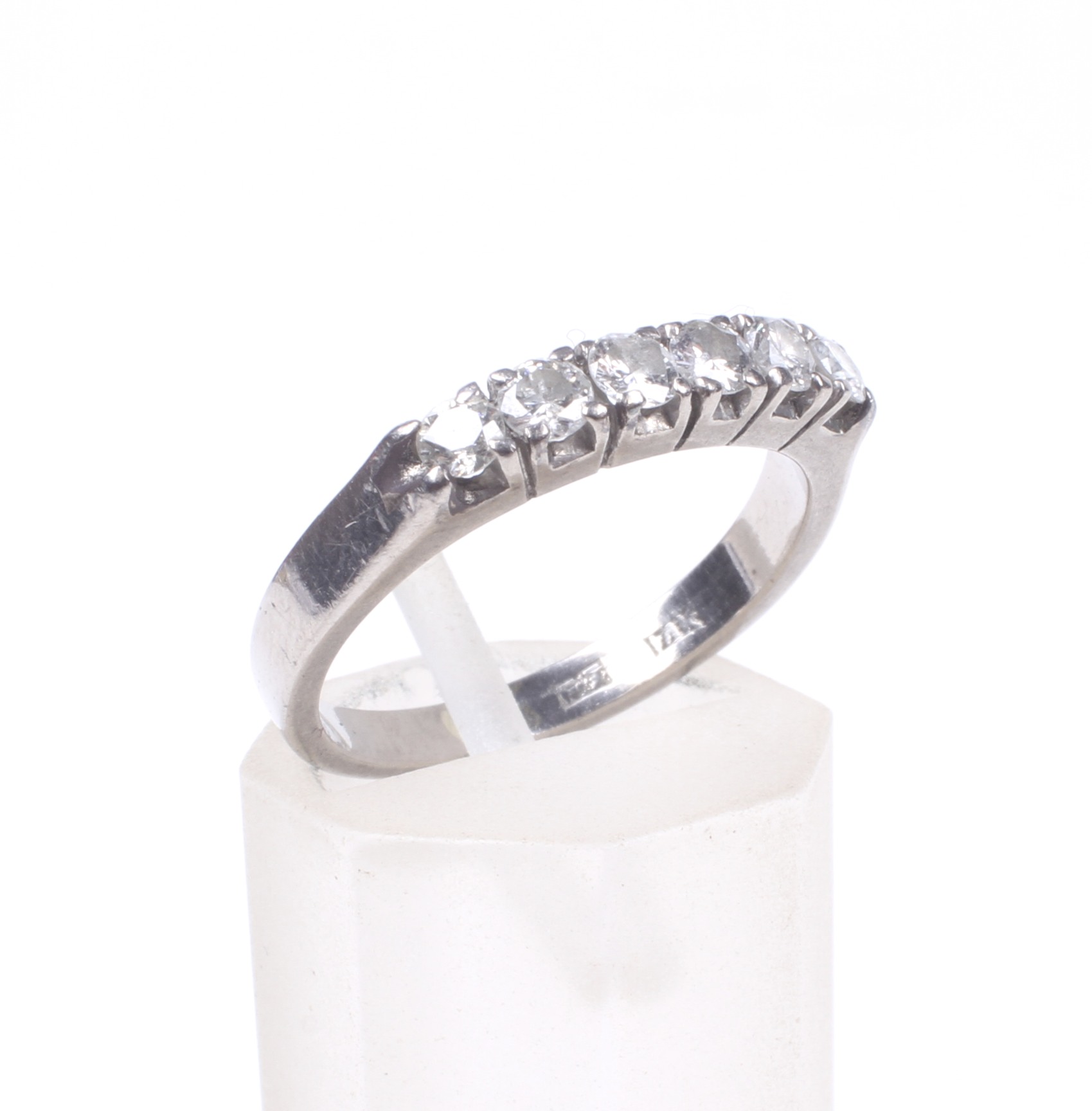 A diamond six stone ring. The round brilliants approx. 0.