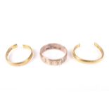 Three gold rings. Comprising two cut 22ct gold wedding bands 8.4 grams, and a 9ct gold band 3.