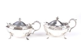 A pair of silver mustard pots.