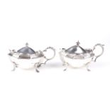 A pair of silver mustard pots.