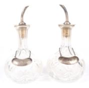 A pair of George V silver mounted glass bitters pourers by Hukin and Heath.