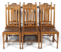 A set of six Arts and Crafts oak dining chairs.