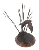 A contemporary Bronze figure group depicting a Duck in flight, amongst bull rushes.