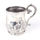A decorative silver tankard. Decorated with cherubs releasing a dove, swags, flowers and foliage.