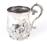 A decorative silver tankard. Decorated with cherubs releasing a dove, swags, flowers and foliage.