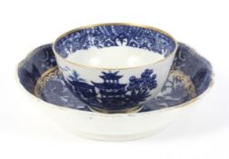A late 18th century Caughley porcelain blue and white teabowl and a saucer.