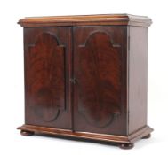 A Victorian mahogany table top miniature four drawer collectors or travelling cabinet.
