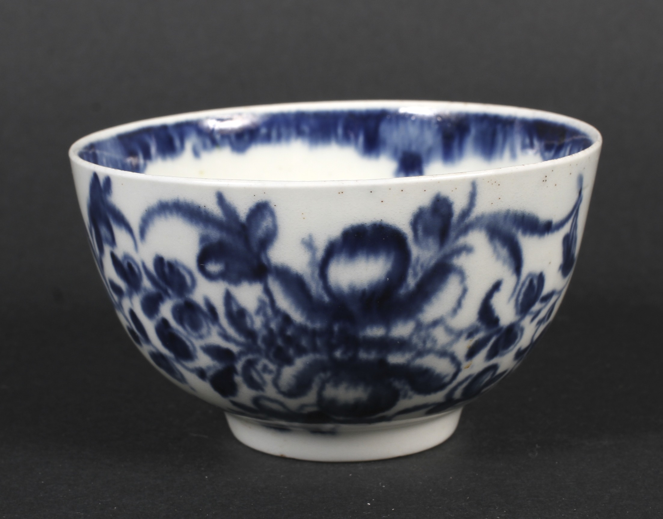 A Worcester porcelain blue and white tea bowl, circa 1765, blue crescent mark.