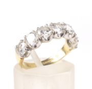 A vintage 18ct gold and diamond seven stone half-eternity ring. The round brilliants approx. 1.