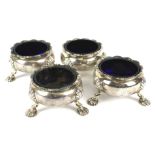 Four 18th Century Georgian silver open salts, with blue glass liners.