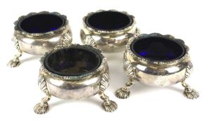 Four 18th Century Georgian silver open salts, with blue glass liners.