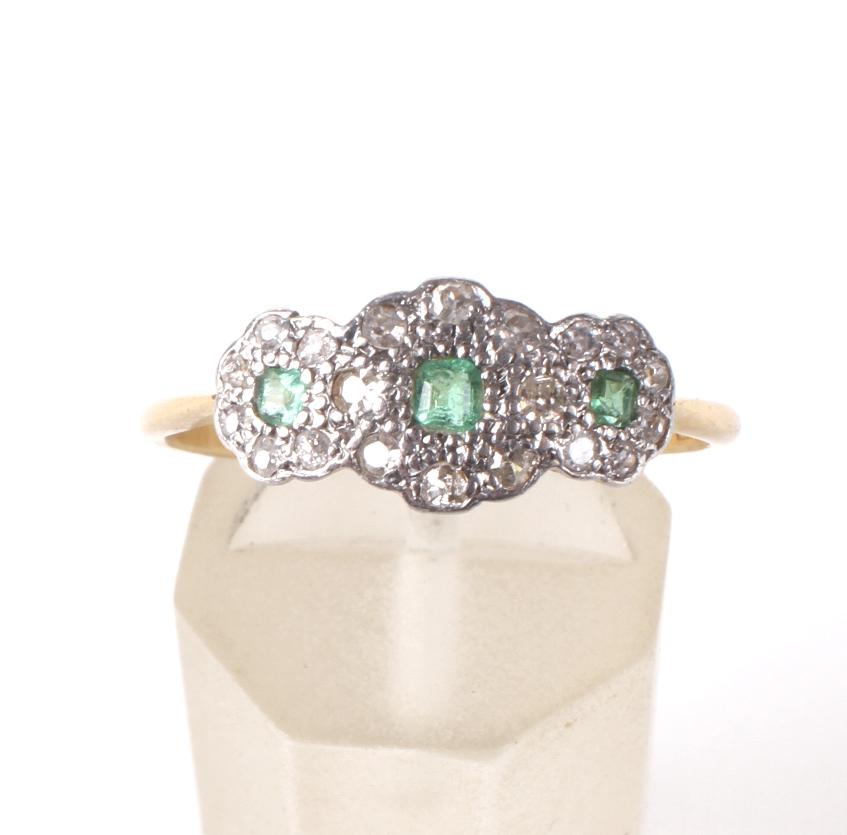 An early 20th century gold, emerald and diamond triple-cluster ring, circa 1930. - Image 2 of 4