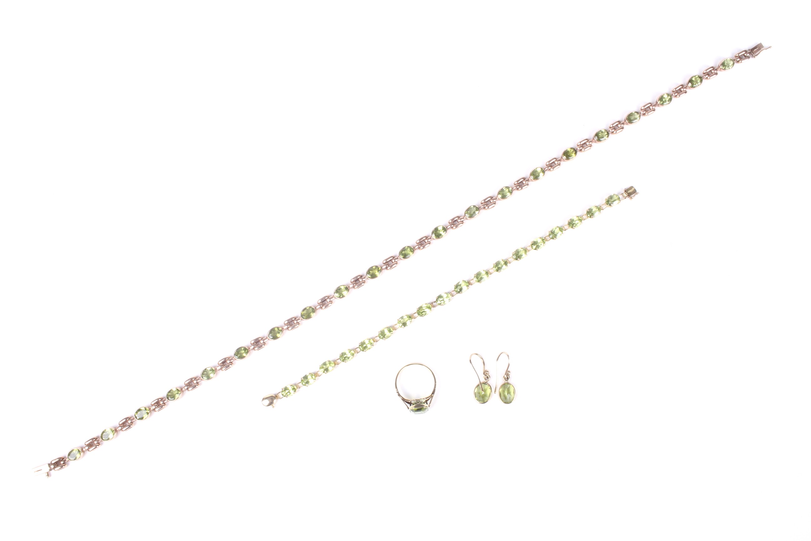 A peridot single stone ring, together with a pair of earrings, a bracelet and a necklace.