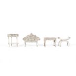 Four assorted miniature silver pieces of furniture.