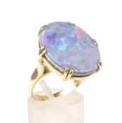 A vintage Italian gold and opal-doublet ring. The oval opal-doublet panel approx. 21.