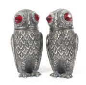 A pair of Continental silver salt and pepper shakers in the form of owls.