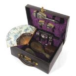 An early 20th century purple ladies leather cased travelling vanity set.