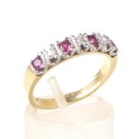 A vintage 18ct gold, ruby and diamond seven stone half-eternity ring.