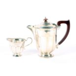 A silver coffee pot and creamer. With beaded and ribbed body raised on a pedestal circular base H17.