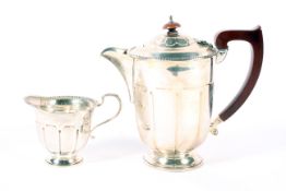 A silver coffee pot and creamer. With beaded and ribbed body raised on a pedestal circular base H17.