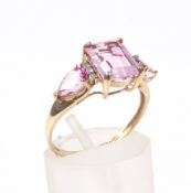 A modern treated pink topaz and diamond dress ring.