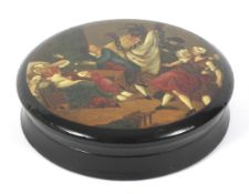 A 19th century lacquered papier mache circular snuff box.