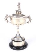 A mid century silver lidded twin handled golfing trophy.