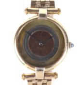 A ladies silver gilt cased Must de Cartier quartz wristwatch on 9ct gold strap.