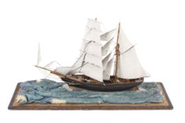 A 19th century diorama of a twin masted scooner.