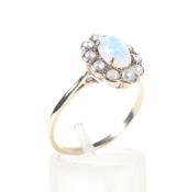 An early-mid 20th century gold, opal and half-pearl oval cluster ring.