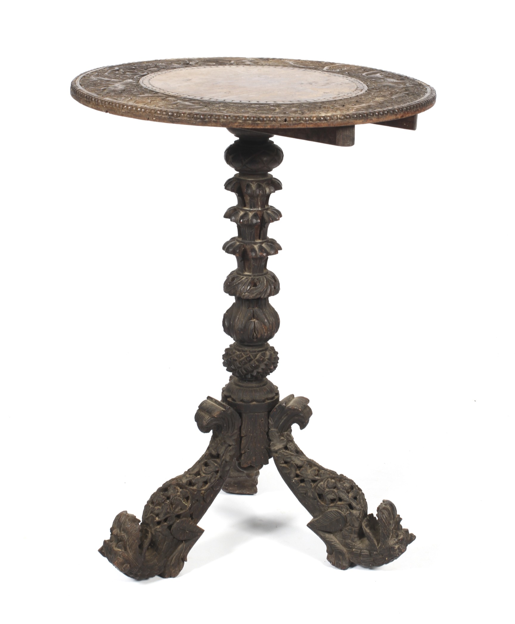 An Anglo-Indian circular tilt top table with carved decoration.