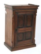 A 19th century mahogany table top cabinet in the form of a cupboard.