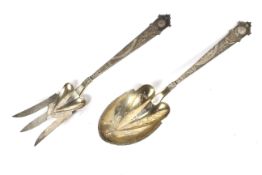 A set of silver continental spoon and fork servers.