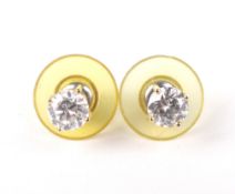 A pair of 18ct gold and diamond solitaire stud earrings. The round brilliants each approx. 0.