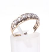A vintage 9ct gold and cubic zirconia seven stone half-eternity ring.