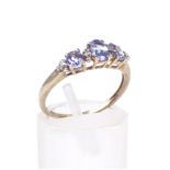 A tanzanite three stone dress ring.