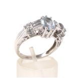 A modern 9ct white gold and topaz dress ring.