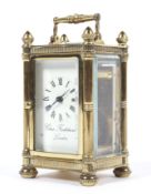 A small brass carriage clock retailed by D Frodsham of London.