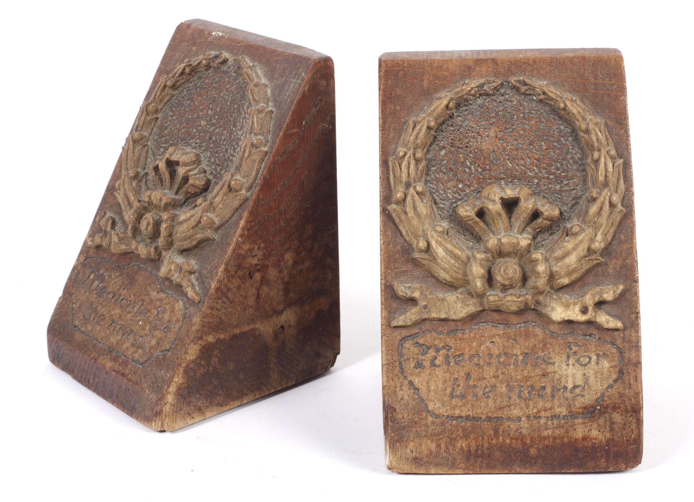 A pair of early 20th century arts and crafts oak bookends.