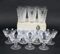 A boxed set of Waterford Crystal cut-glass tumblers and seven Champagne glasses.