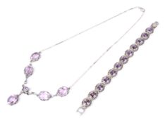 A purple synthetic-sapphire bracelet and a pink stone necklace.