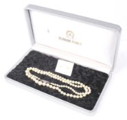 A cultured pearl single row necklace and a pair of stud earrings.