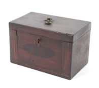 A Georgian mahogany tea caddy. With ring handle and key, the rising lid to twin compartments.